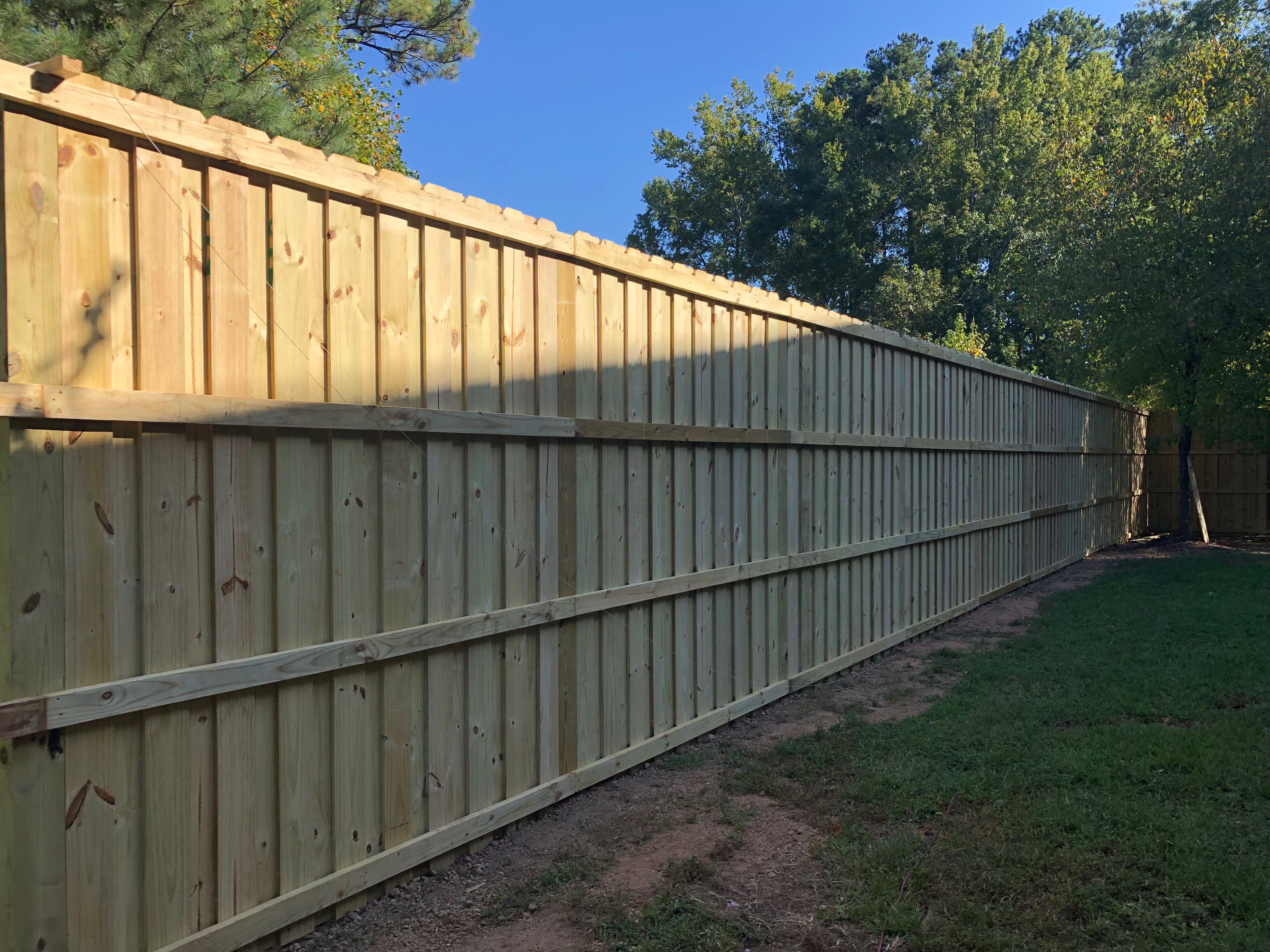 Wood privacy fence installation